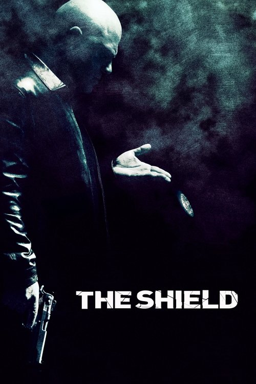 The poster features a shadowy figure in dark clothing against a smoky, ominous background, evoking a sense of mystery and danger. The title "THE SHIELD" is prominently displayed in bold white letters, suggesting a serious and intense narrative.