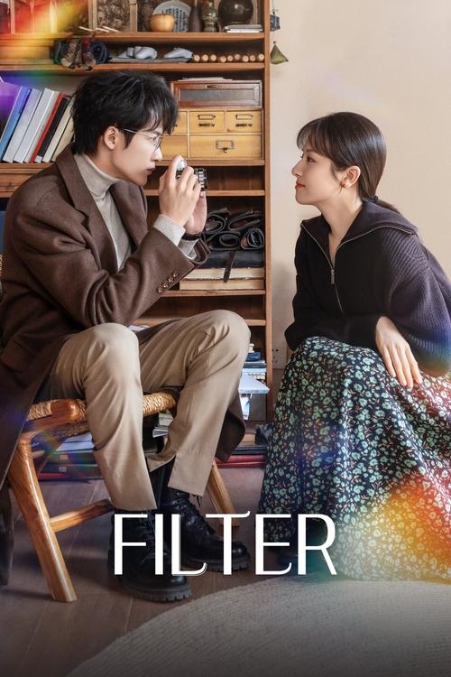 The poster features a man in a brown suit and a woman in a patterned skirt, sitting in a cozy room with shelves of books and a warm, intimate atmosphere. The title "FILTER" is prominently displayed in bold white letters at the bottom, suggesting a dramatic or emotional story about relationships a...