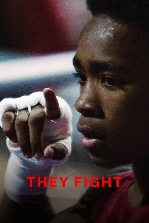 The poster captures a dramatic moment of intense action, featuring a young athlete in a red uniform, wrapped in white bandages, with a focused expression. The bold red text "THEY FIGHT" stands out against the dark background, emphasizing the theme of competition and struggle.