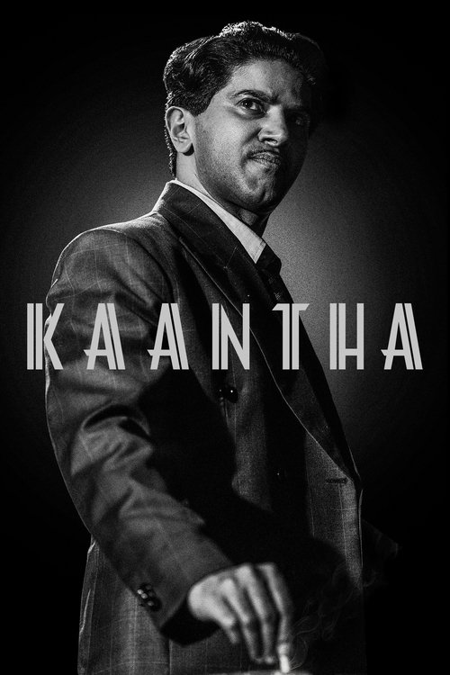The poster features a man in a dark suit against a black background, exuding mystery and sophistication. The title "KAANTHA" is prominently displayed in bold white letters, suggesting a dramatic or intense narrative. The overall mood is mysterious and cinematic, hinting at a complex story with de...