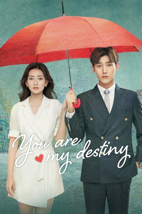 A couple stands under a vibrant red umbrella against a teal backdrop, exuding romance and charm. The man in a sharp suit and the woman in a stylish white outfit create a striking visual contrast. The tagline "You are my destiny" adds a touch of elegance and emotional depth to the scene.