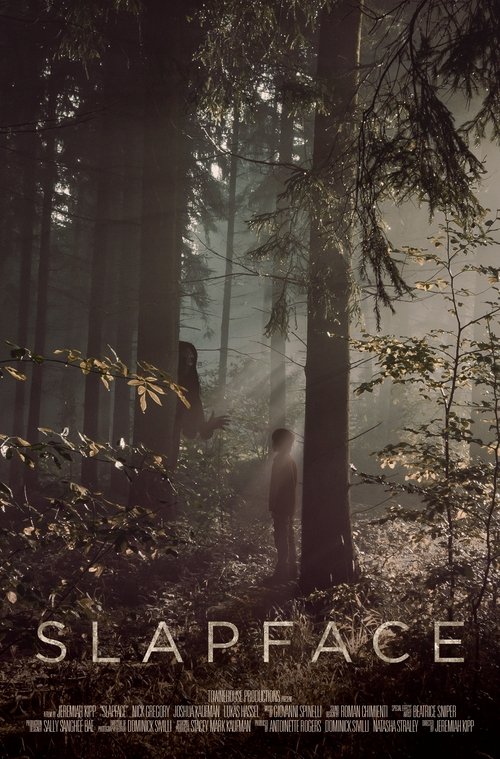 A lone figure stands in a misty forest, surrounded by tall trees and dappled sunlight. The muted, sepia-toned palette evokes a somber, mysterious atmosphere. The title "SLAPFACE" is prominently displayed at the bottom, hinting at the film's dark and unsettling tone.