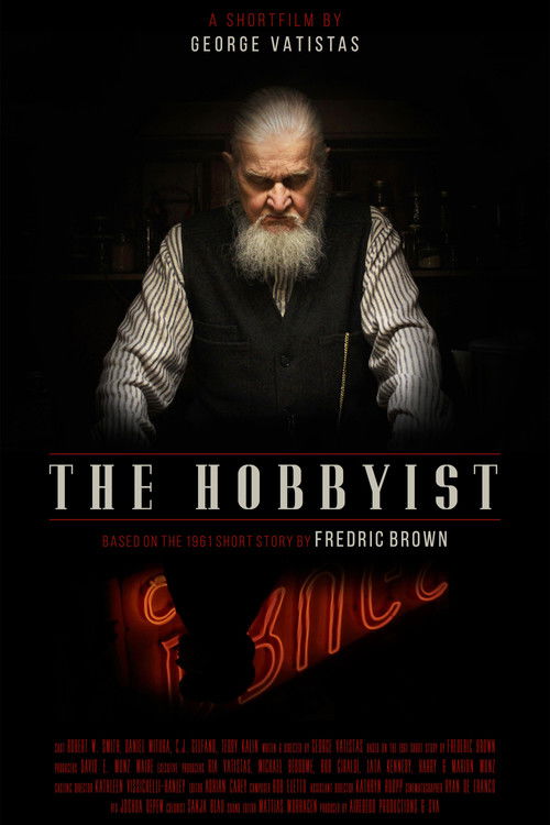 The poster features a somber portrait of George Vatasas, a man with a white beard and intense gaze, set against a dark, moody background. The title "The Hobbyist" is prominently displayed in bold, distressed typography, evoking a gritty, noir atmosphere. The overall mood is one of intrigue and su...