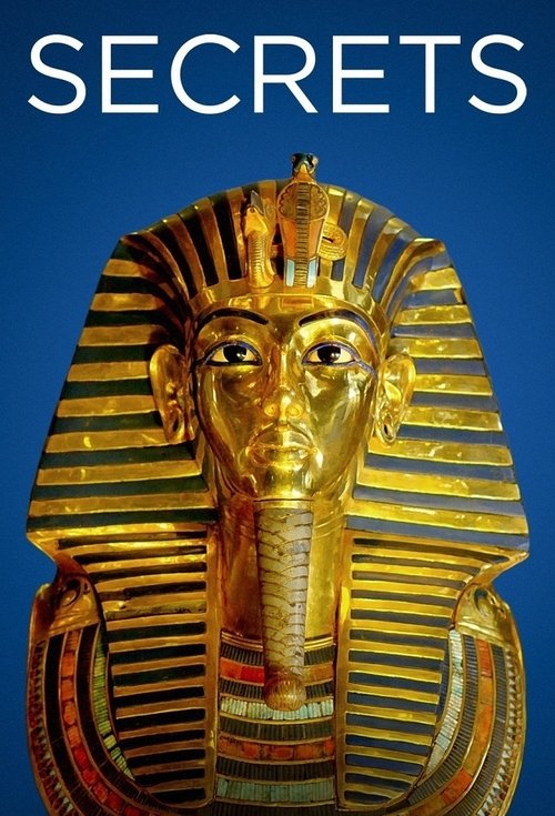 The poster features a golden Egyptian pharaoh mask against a deep blue background, evoking mystery and ancient history. The bold white text "SECRETS" dominates the top, suggesting hidden truths or revelations. The rich gold and blue tones create a striking contrast, while the solemn expression of...