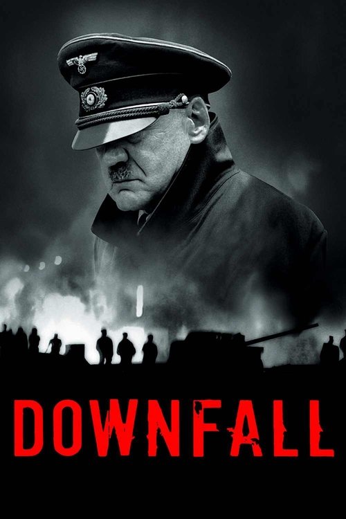 The poster features a somber black-and-white portrait of a man in a military uniform against a backdrop of dark, smoky figures. The word "DOWNFALL" appears in bold red letters at the bottom, evoking a sense of impending doom and historical tragedy.