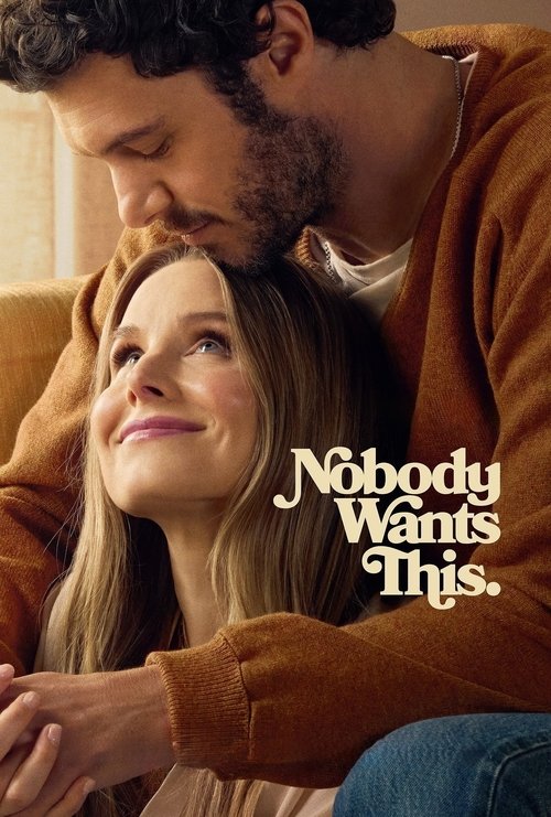 The poster features a tender moment between two men, one with dark hair and the other with light hair, both wearing brown sweaters. The warm lighting and intimate expressions convey a sense of closeness and affection. The title "Nobody Wants This" is elegantly displayed in white text against the ...