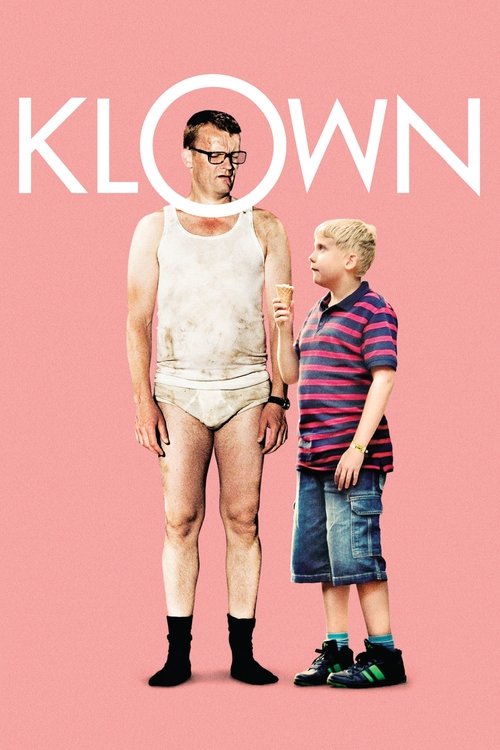 The poster features a muscular man in a white tank top and shorts standing next to a young boy in a striped shirt and denim shorts. Both characters are dressed in everyday clothes, suggesting a casual, everyday setting. The background is a solid pink color, and the title "KLOWN" is prominently di...