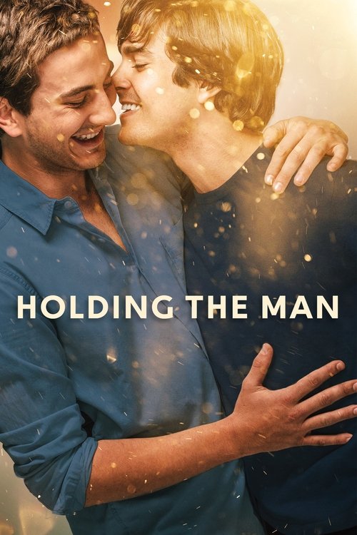 The poster features a tender moment between two men sharing an intimate kiss, with warm golden hues and sparkling particles enhancing the romantic atmosphere. The title "Holding the Man" is prominently displayed in bold white letters, emphasizing the emotional connection and love between the char...