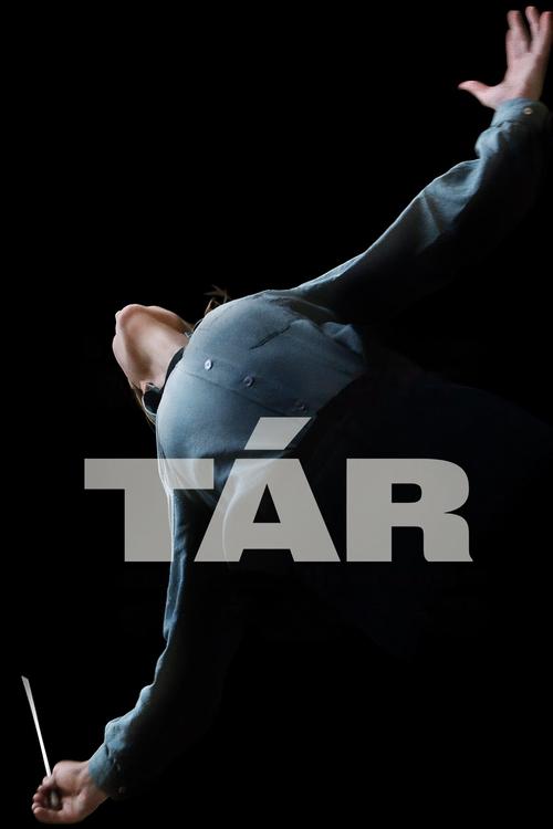 The dark background highlights a conductor in motion, with a spotlight illuminating their expressive posture. The word "TÁR" dominates the center, creating a striking contrast against the silhouette.