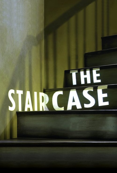 The poster features a dramatic staircase with bold, illuminated text reading "THE STAIRCASE." The warm, golden lighting creates an eerie atmosphere, while the shadowy figure in the background adds mystery.