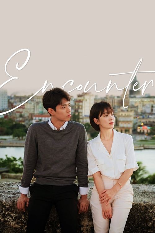 The poster features a couple sitting on a stone ledge overlooking a scenic cityscape, with soft pastel tones and a romantic, contemplative mood.