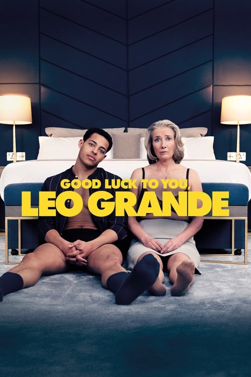 The poster features a couple sitting on a bed in a dimly lit room, exuding a relaxed and intimate mood. The warm glow from the lamps contrasts with the cool blue tones of the room, creating a cozy atmosphere. The bold yellow text "Good Luck to You, Leo Grande" stands out against the darker backgr...