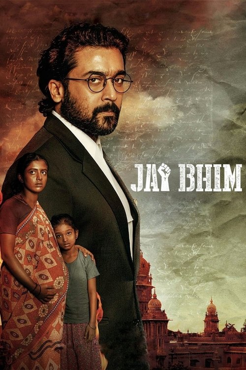 The poster features a man in a dark suit with a beard, wearing glasses, standing prominently against a dramatic sky. Behind him, a woman in a vibrant red patterned dress and a child in a blue shirt add depth to the composition. The title "Jai Bhim" is boldly displayed in white letters. The overal...