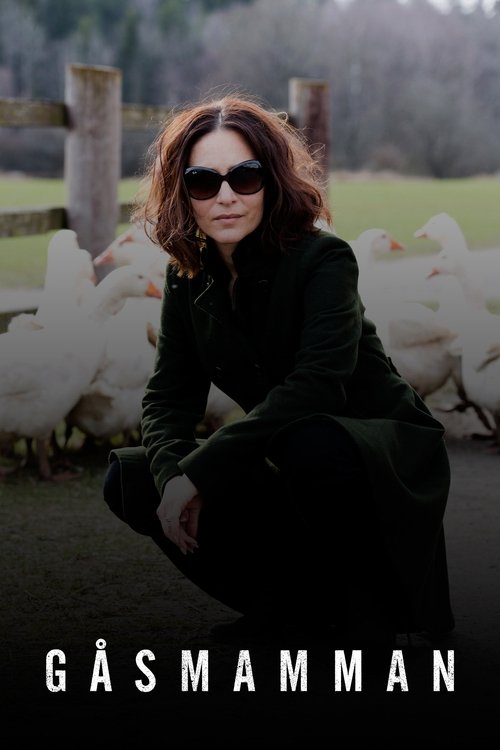 A woman in a dark green coat crouches on a farm, surrounded by white chickens and a wooden fence. The muted earthy tones and soft lighting evoke a serene, pastoral mood.