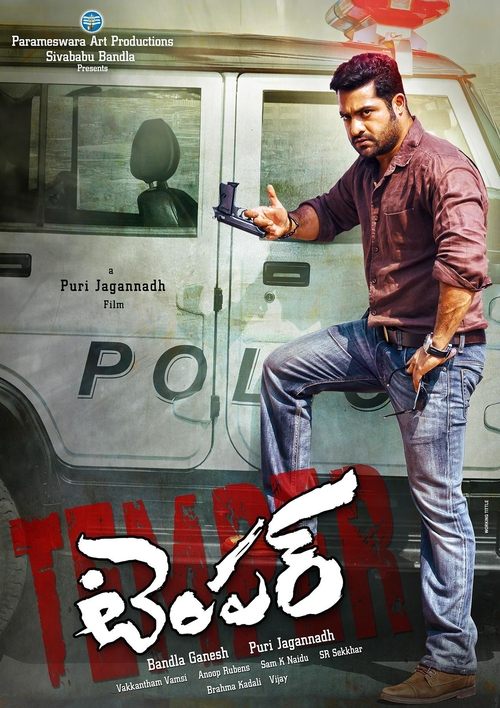 A rugged man in a maroon shirt and jeans stands confidently beside a police van, holding a gun. The poster features bold red and white text, evoking a gritty, action-packed atmosphere.