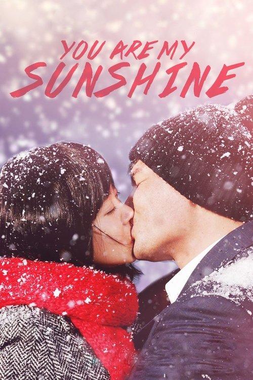 The poster features a couple sharing a tender kiss in a snowy winter scene, with the title "You Are My Sunshine" prominently displayed in bold red letters. The warm colors of their clothing contrast beautifully with the cool, white snow, evoking a romantic and joyful mood.