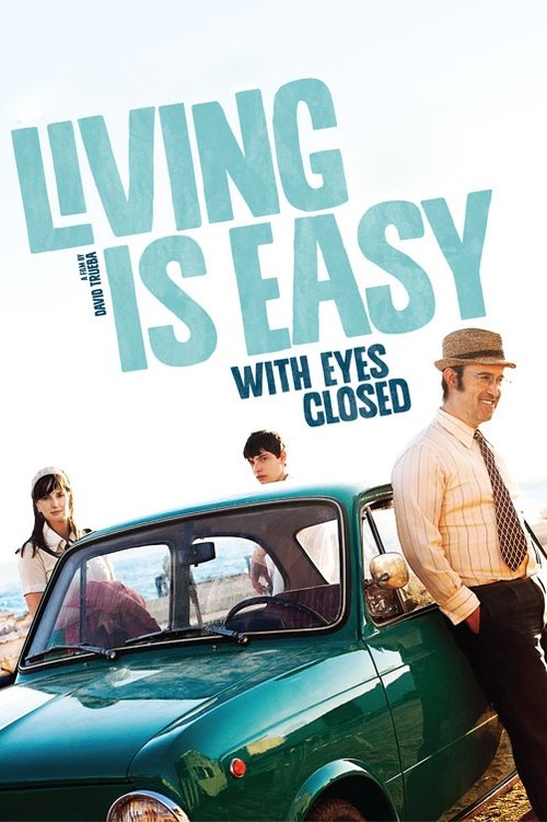 The poster features a vibrant green vintage car and a man in a hat, exuding a relaxed, carefree vibe. The title "Living Is Easy" is prominently displayed in bold, light blue letters, suggesting a simple, straightforward life. The overall color palette of greens, whites, and soft blues creates a c...