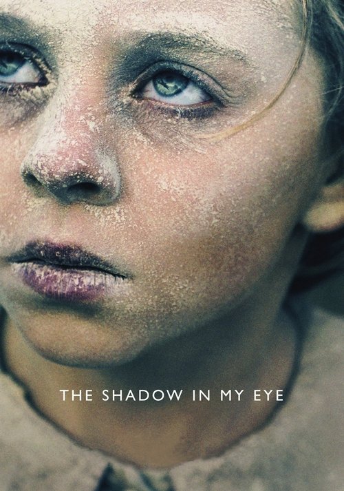 The poster features a young girl with pale skin and dark circles under her eyes, her gaze intense and sorrowful. The muted, earthy tones of the image evoke a somber mood, while the title "The Shadow in My Eye" hints at a story about hidden emotions and personal struggles.