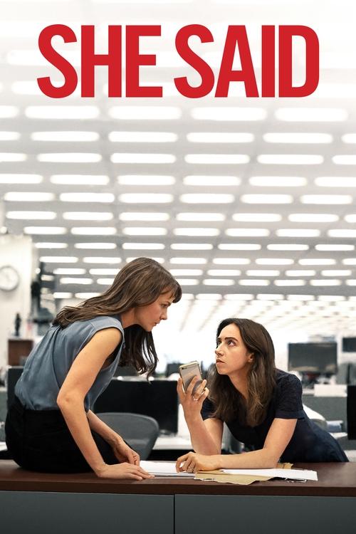 The poster features two women in a modern office setting, with one leaning over the other. The bold red title "SHE SAID" dominates the top, while the warm lighting and professional atmosphere convey a sense of intrigue and drama.