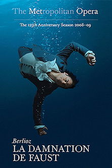 The poster features a dramatic underwater scene with a man in a dark suit and white cravat, seemingly submerged in deep blue water. The title "The Metropolitan Opera" is prominently displayed at the top, while "Berlioz: La Damnation de Faust" appears at the bottom. The overall mood is mysterious ...