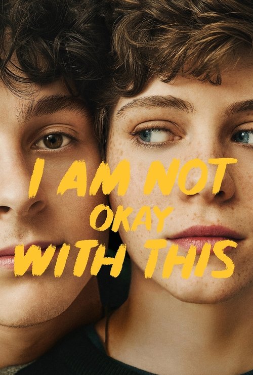 The poster features two young people with intense, direct gazes, creating a sense of confrontation. The bold yellow text "I AM NOT OKAY WITH THIS" dominates the center, emphasizing the emotional weight of the message. The warm, slightly desaturated tones evoke a somber mood, suggesting themes of ...