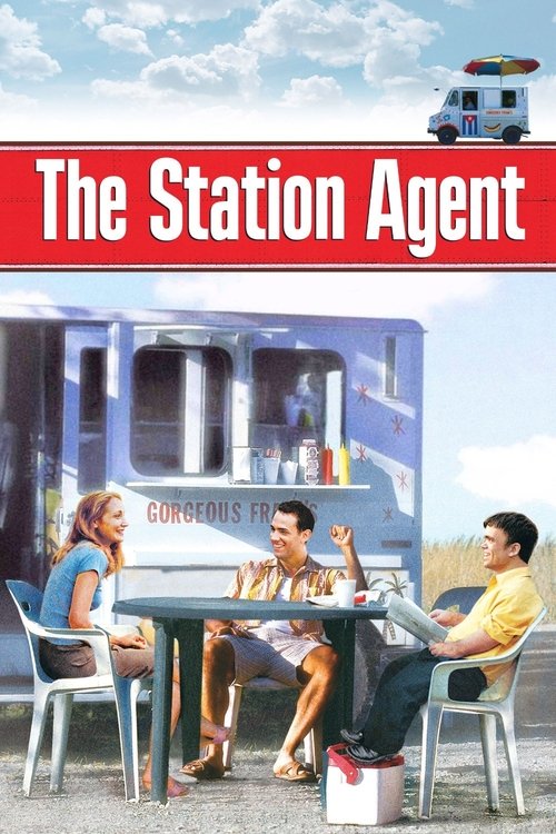 The Station Agent poster features a vibrant scene with three characters seated at a table under a bright blue sky. A police van looms in the background, suggesting an action-packed adventure. The colors are vivid, with reds, blues, and yellows creating a cheerful atmosphere. The mood is lively an...