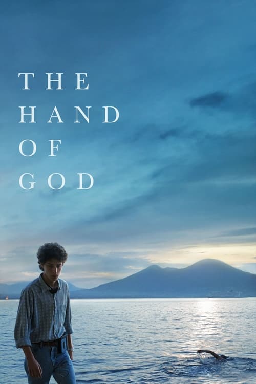 The poster features a solitary figure standing on the shore, gazing out at a serene, expansive landscape. The muted blues and greens of the sky and water evoke a sense of calm and introspection. The title "The Hand of God" is elegantly placed in the upper left corner, suggesting themes of faith a...