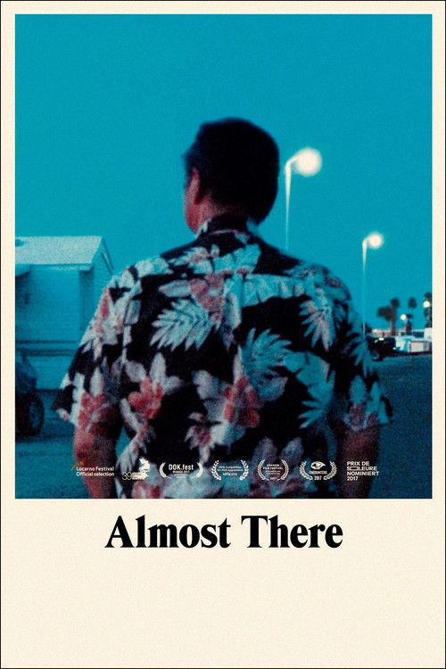 The poster features a person in a floral shirt viewed from behind, standing on a beach at twilight. The cool blue tones evoke a sense of mystery and introspection. The title "Almost There" suggests a journey or exploration.
