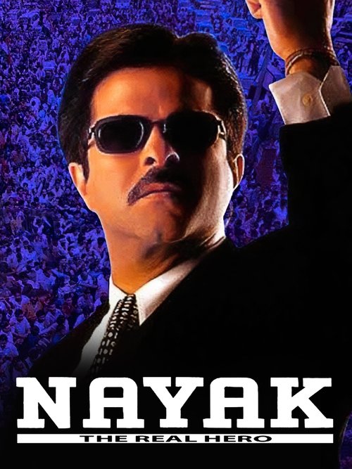The poster features a man in sunglasses and a suit against a dark, textured background. The title "NAYAK: THE REAL HERO" is prominently displayed at the bottom. The overall mood is intense and dramatic, emphasizing the character's powerful presence.