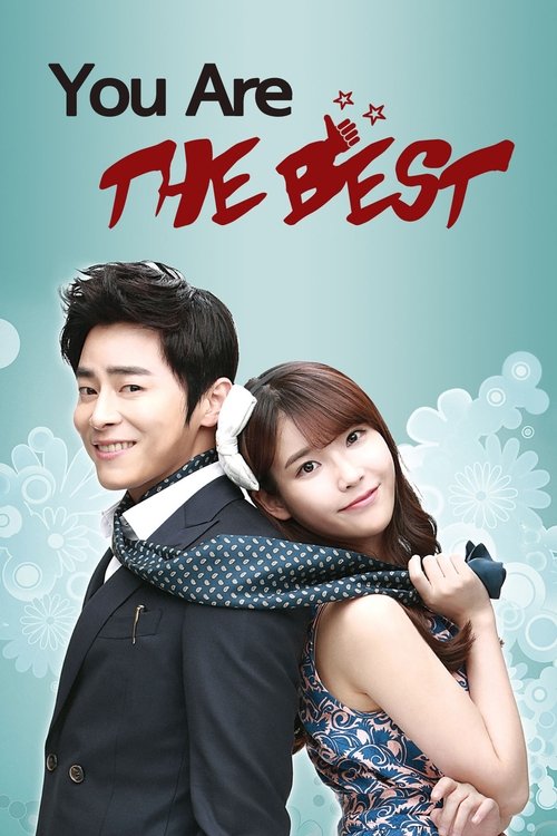 The poster features a romantic couple embracing against a soft teal background with subtle snowflakes. The man in a dark suit and the woman in a blue dress exude warmth and charm. Bold red text announces "You're the Best," evoking a playful and affectionate tone.