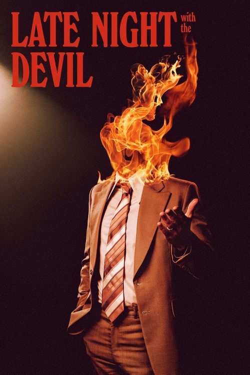 The poster features a man in a suit and tie, his head engulfed in flames against a dark background. The fiery orange and yellow hues dominate the image, creating a dramatic and intense atmosphere. The title "Late Night with the Devil" is prominently displayed in bold red letters at the top.