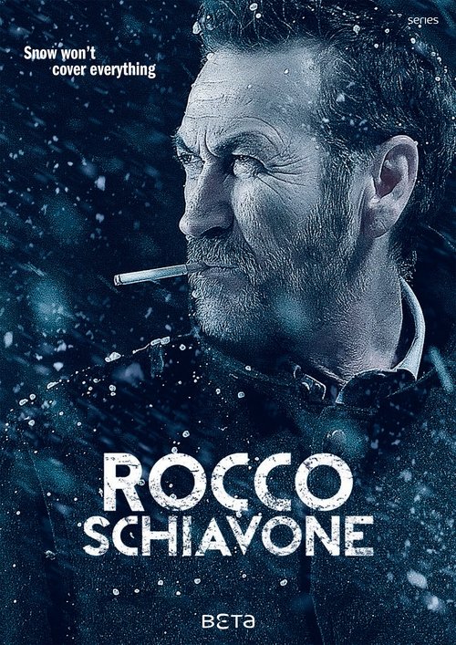 The poster features a rugged man with a cigarette, set against a dark, snowy backdrop. The title "ROCCO SCHIAVONE" is prominently displayed in bold white letters. The overall mood is intense and dramatic, with a cold, wintry atmosphere that hints at a gritty, action-packed storyline.