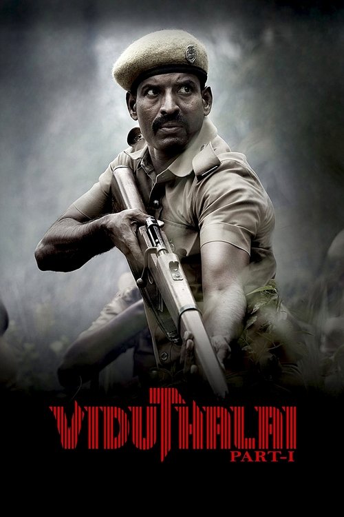 The poster features a rugged soldier in a beige uniform holding a rifle against a dark, stormy backdrop. The title "Viduthalai" is prominently displayed in bold red letters at the bottom, evoking a sense of historical drama and action. The overall mood is intense and dramatic, capturing the essen...