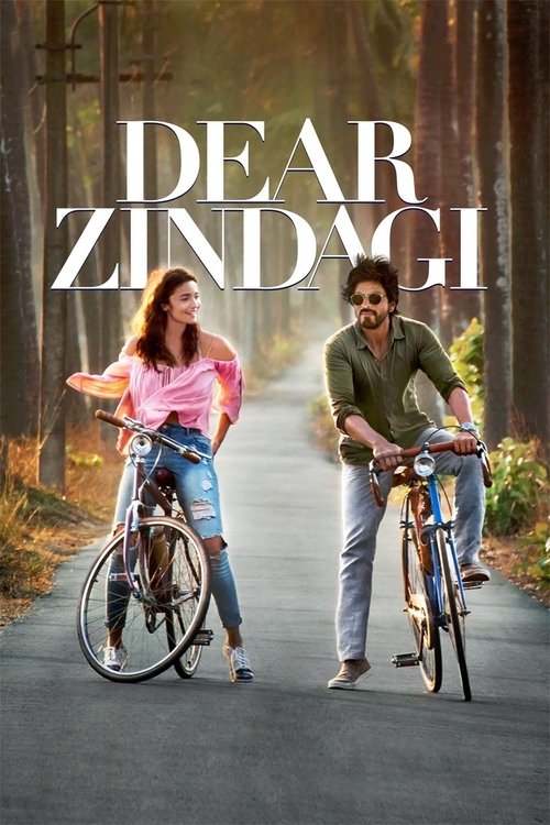 The poster features a romantic couple on bicycles, with the title "Dear Zindagi" prominently displayed in bold white letters. The warm, golden sunlight bathes the scene, creating a nostalgic and dreamy atmosphere. The couple's cheerful expressions and the serene forest backdrop evoke a sense of t...