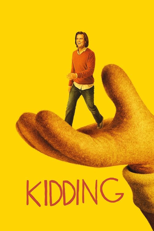 The poster features a man in a red sweater standing on a large, open palm against a bright yellow background. The title "KIDDING" appears in bold red letters at the bottom, evoking a playful and humorous tone.