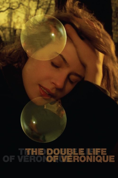 The poster features a woman with her eyes closed, resting her head on her hand, surrounded by large, translucent bubbles that glow softly. The warm, golden lighting creates a dreamy atmosphere, while the title "The Double Life of Véronique" is elegantly displayed at the bottom.