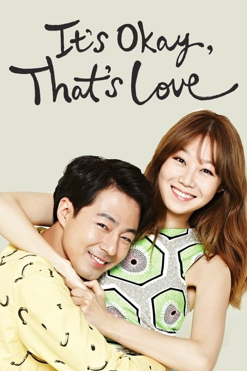 The poster features a warm, intimate scene with two people embracing. The man wears a yellow shirt with black patterns, while the woman dons a green and white patterned top. Their expressions convey affection and happiness. The title "It's Okay, That's Love" is elegantly written at the top, setti...