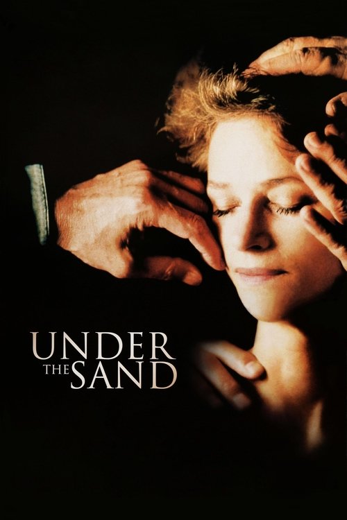 This movie poster features a woman with eyes closed, her face illuminated against a dark background. A hand gently touches her forehead, creating an intimate and serene mood. The title "UNDER THE SAND" is prominently displayed in white text.