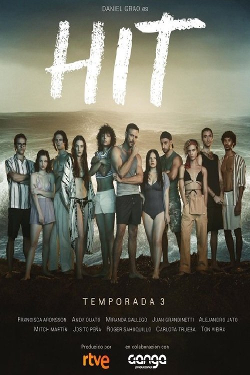 The poster features a group of diverse individuals standing on a beach, exuding a relaxed and casual atmosphere. The warm sunset hues blend with the natural tones of the sand and water, creating a serene and inviting mood. The bold "HIT" title dominates the top, suggesting a popular and engaging ...