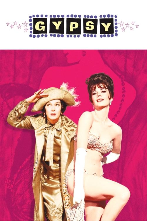 The poster features two glamorous women in vibrant pink and gold attire, exuding a dreamy, romantic atmosphere. The title "GYPSY" is prominently displayed at the top in bold, playful lettering.
