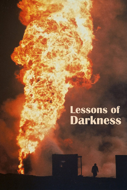 The poster depicts a dramatic scene with a towering inferno dominating the frame, casting a fiery glow against the dark sky. Silhouetted figures stand in the foreground, evoking a sense of isolation and introspection. The title, "Lessons of Darkness," is subtly placed in the center, hinting at th...