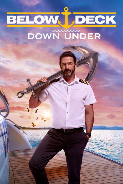 The poster features a rugged man in a white shirt and dark pants standing confidently on a wooden deck, holding a large fishing rod. The background showcases a vibrant sunset with warm hues of orange, pink, and purple blending into the sky. A boat is partially visible on the left, while the ocean...