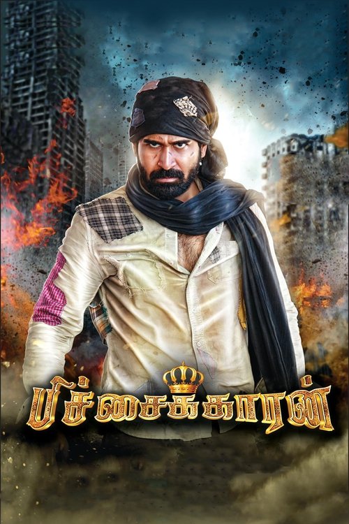 The poster features a rugged man in traditional attire, exuding strength and resilience against a backdrop of burning cityscapes. The warm tones of his clothing contrast with the fiery explosions, creating a dramatic and intense mood. The title "Pichaikkaran" is prominently displayed at the botto...