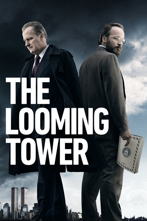 The poster features two men in formal suits against a dramatic sky, evoking a sense of mystery and intrigue. The bold white text "THE LOOMING TOWER" dominates the foreground, suggesting a suspenseful narrative. The muted tones of the buildings in the background add depth, while the cloudy sky enh...