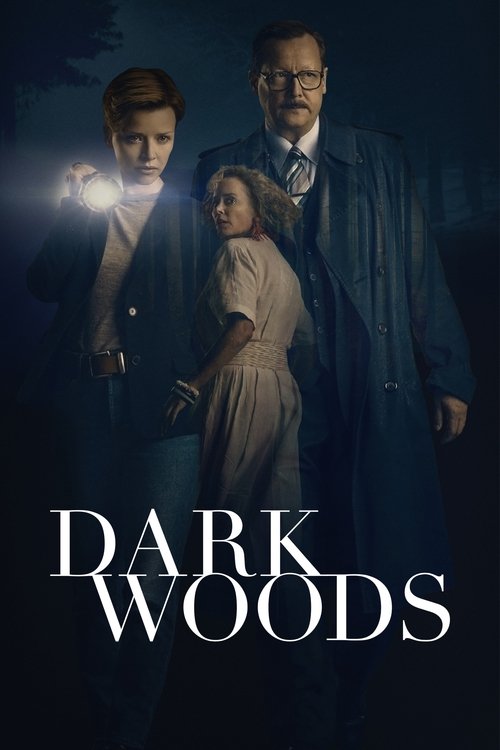 The poster features three characters in a moody, dark setting with deep blues and blacks. A man in a trench coat stands prominently, while a woman in a light-colored dress is positioned between him and another figure. The title "DARK WOODS" is displayed in bold, white letters at the bottom, evoki...