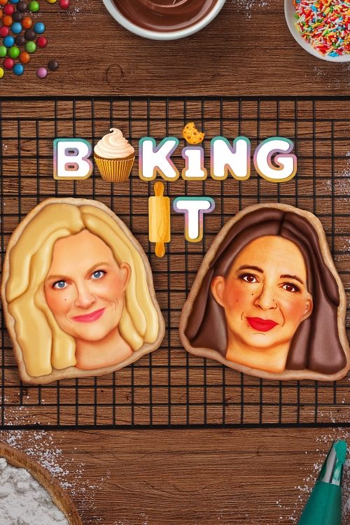 This TV show poster for "Baking It" features two smiling faces on cookie dough, evoking a warm, inviting atmosphere. The pastel colors and cheerful expressions create a fun and approachable vibe, perfect for baking enthusiasts.