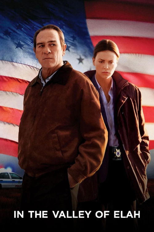 The poster features two characters standing against a backdrop of the American flag, with a somber and serious mood. The man in a brown jacket and the woman in a dark coat exude a sense of determination and resolve, while the flag's red and white stripes and blue field symbolize the American flag...