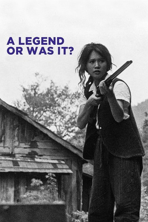 The poster features a hauntingly realistic black-and-white image of a woman with long hair, holding a shotgun over a rustic wooden structure. The stark monochrome palette and somber mood evoke a sense of mystery and danger. The text "A LEGEND OR WAS IT?" adds an intriguing twist to the scene.