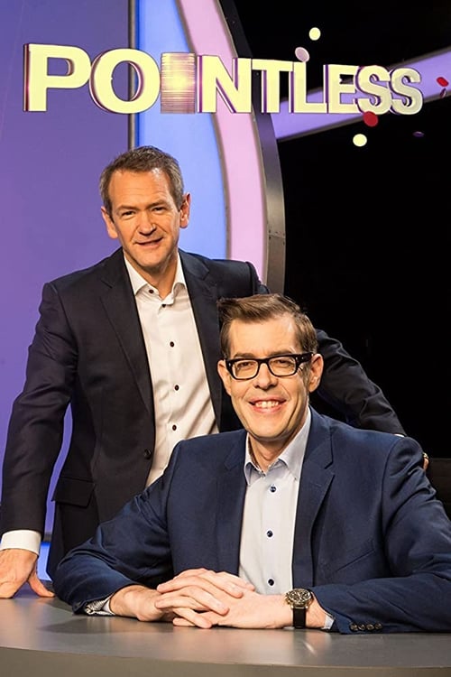 Two men stand behind a desk, one in a dark suit and the other in a blue jacket, both smiling at the camera. The background features vibrant purple and pink hues with the show's title prominently displayed.