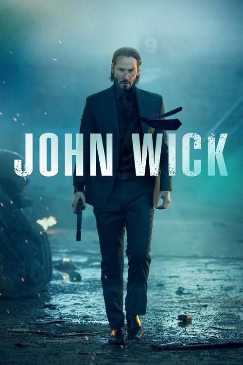 The poster features a determined man in a dark suit walking forward, holding a gun, against a moody, misty background. The title "JOHN WICK" is prominently displayed in bold white letters. The overall mood is intense and suspenseful, with cool tones and dramatic lighting.
